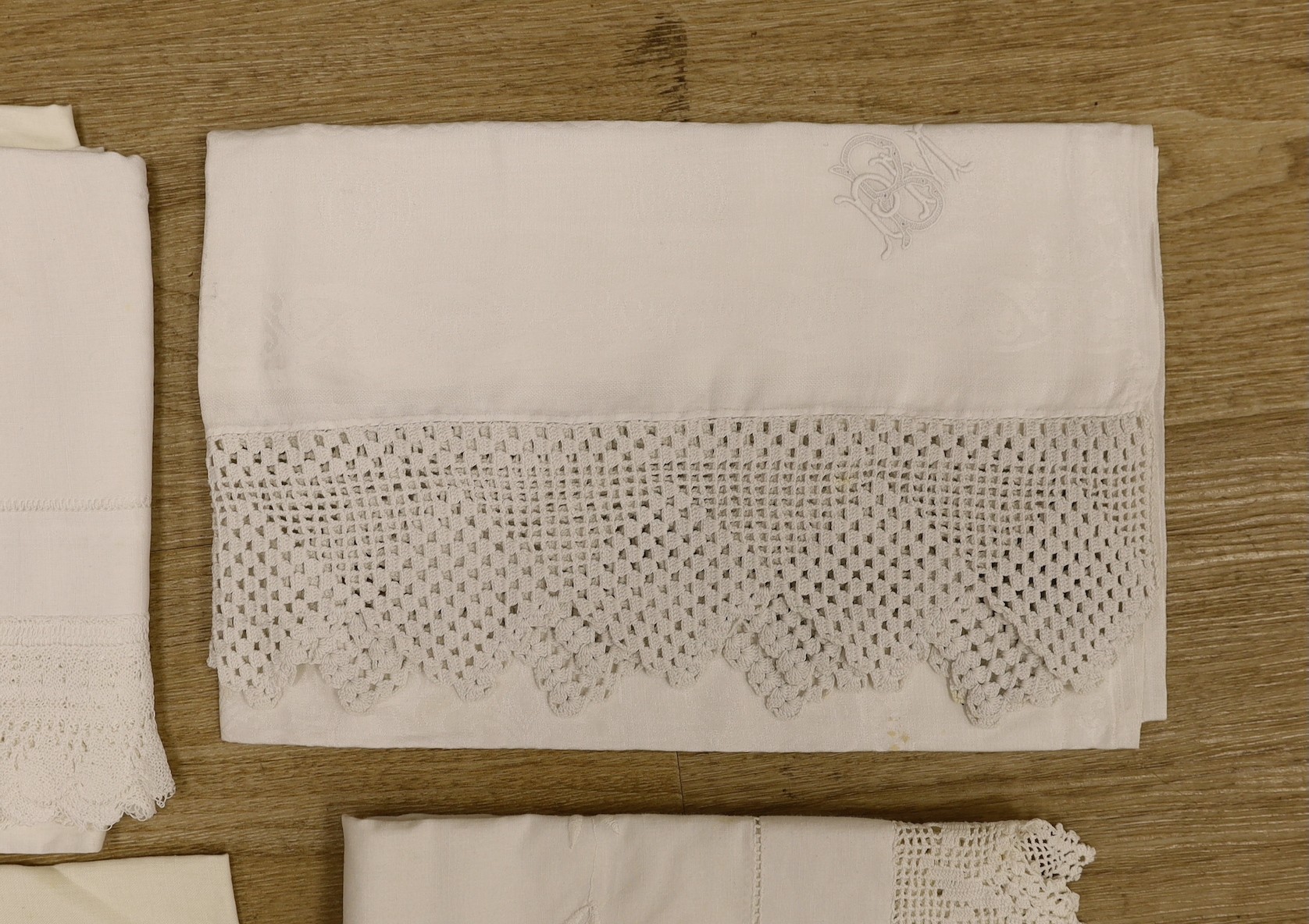 A quantity of lace trimmed and embroidered fabrics including tray cloths and pillow cases